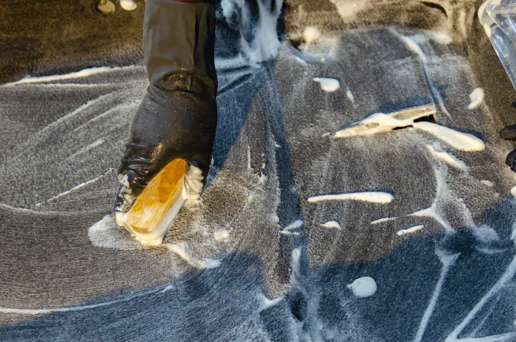 A rug being blotted clean with a cloth