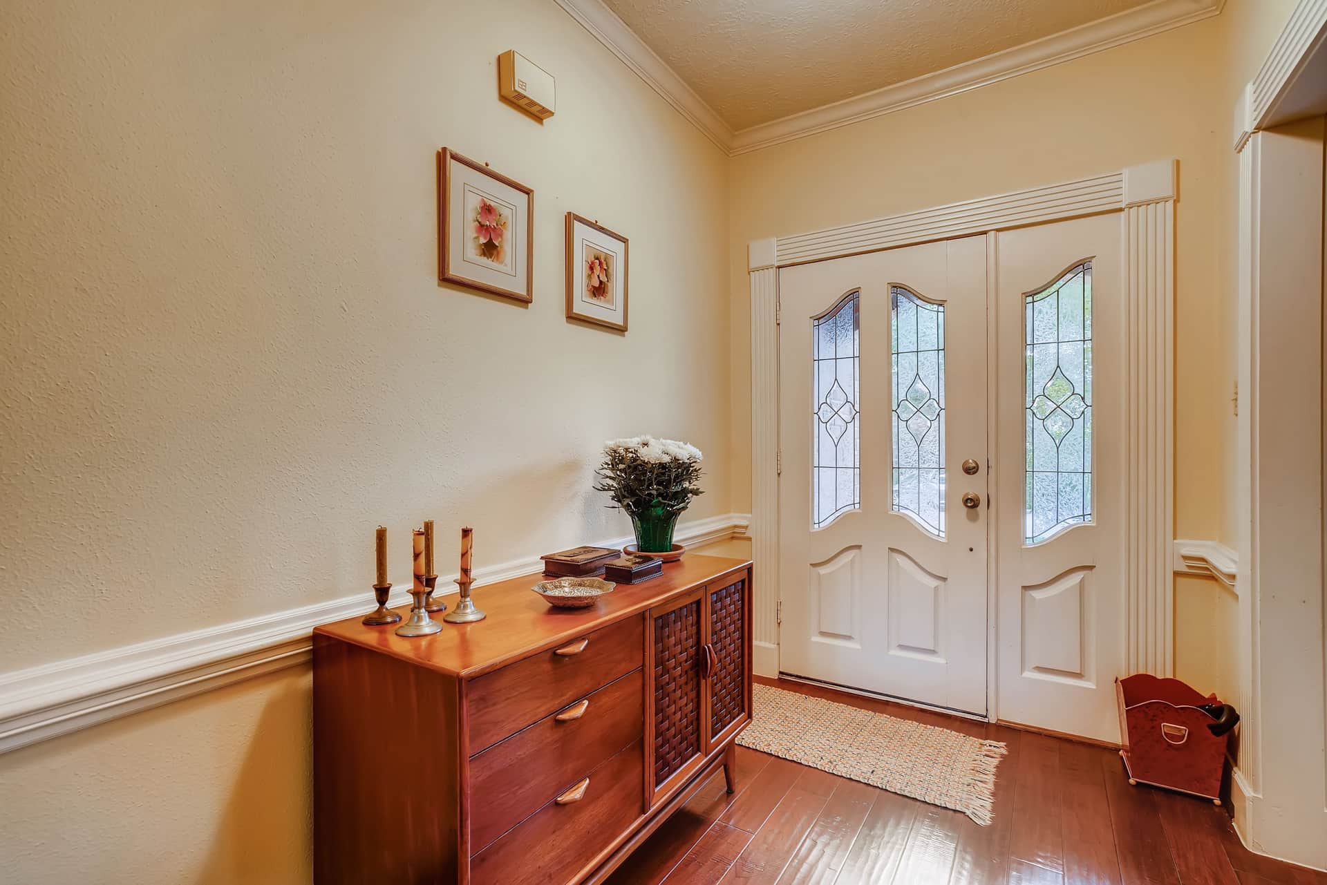 A small accent rug on the floor just inside a front door