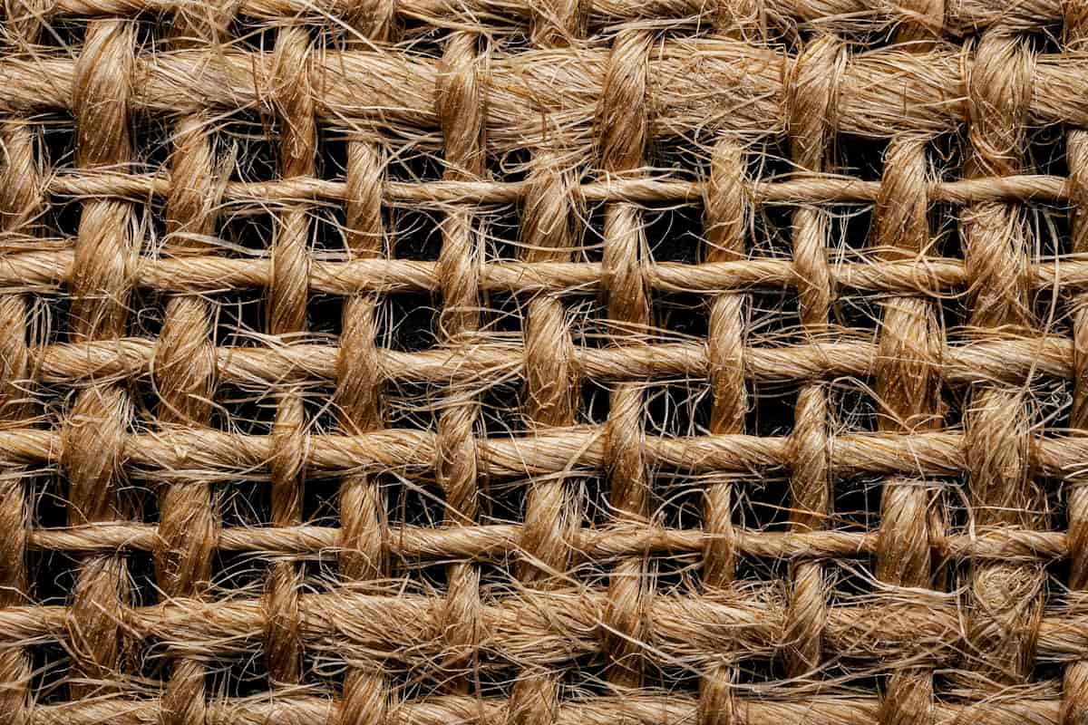 A woven jute rug showing its natural fiber texture up close