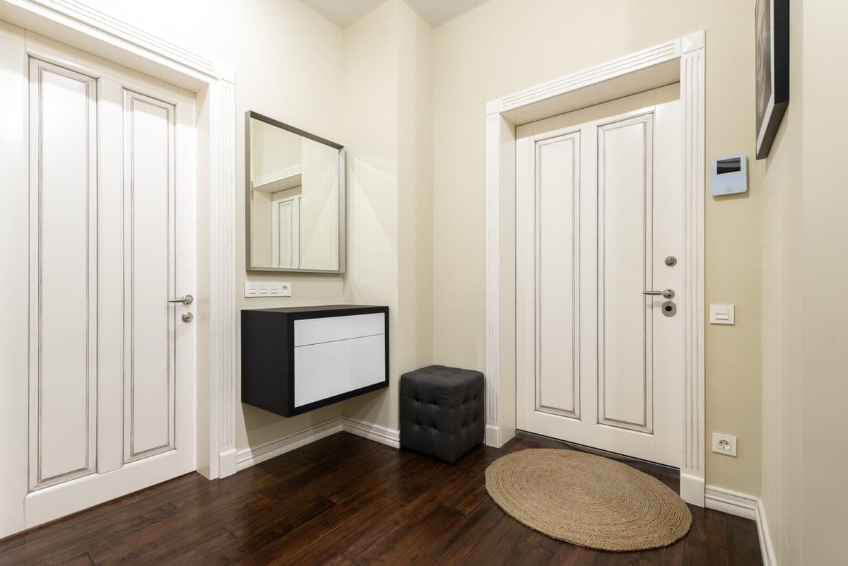 A narrow patterned runner along a hallway floor