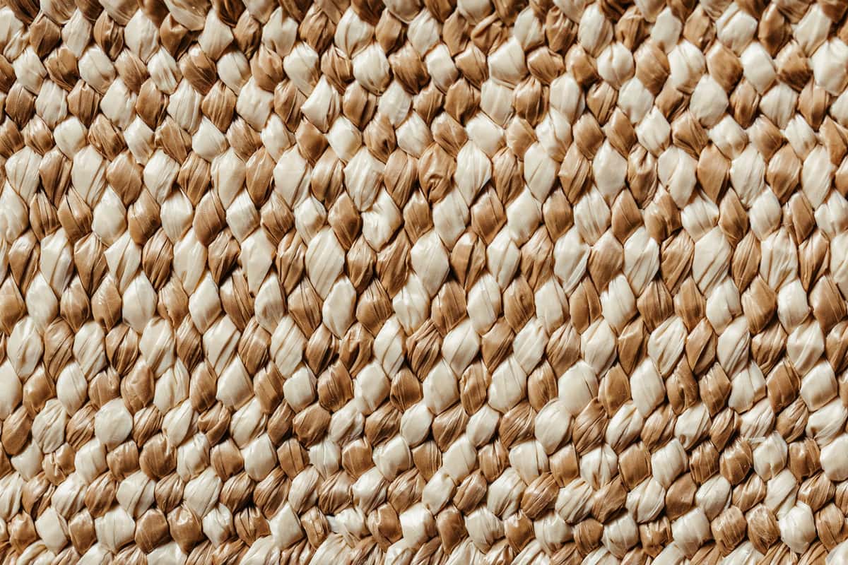 A sisal rug being vacuumed